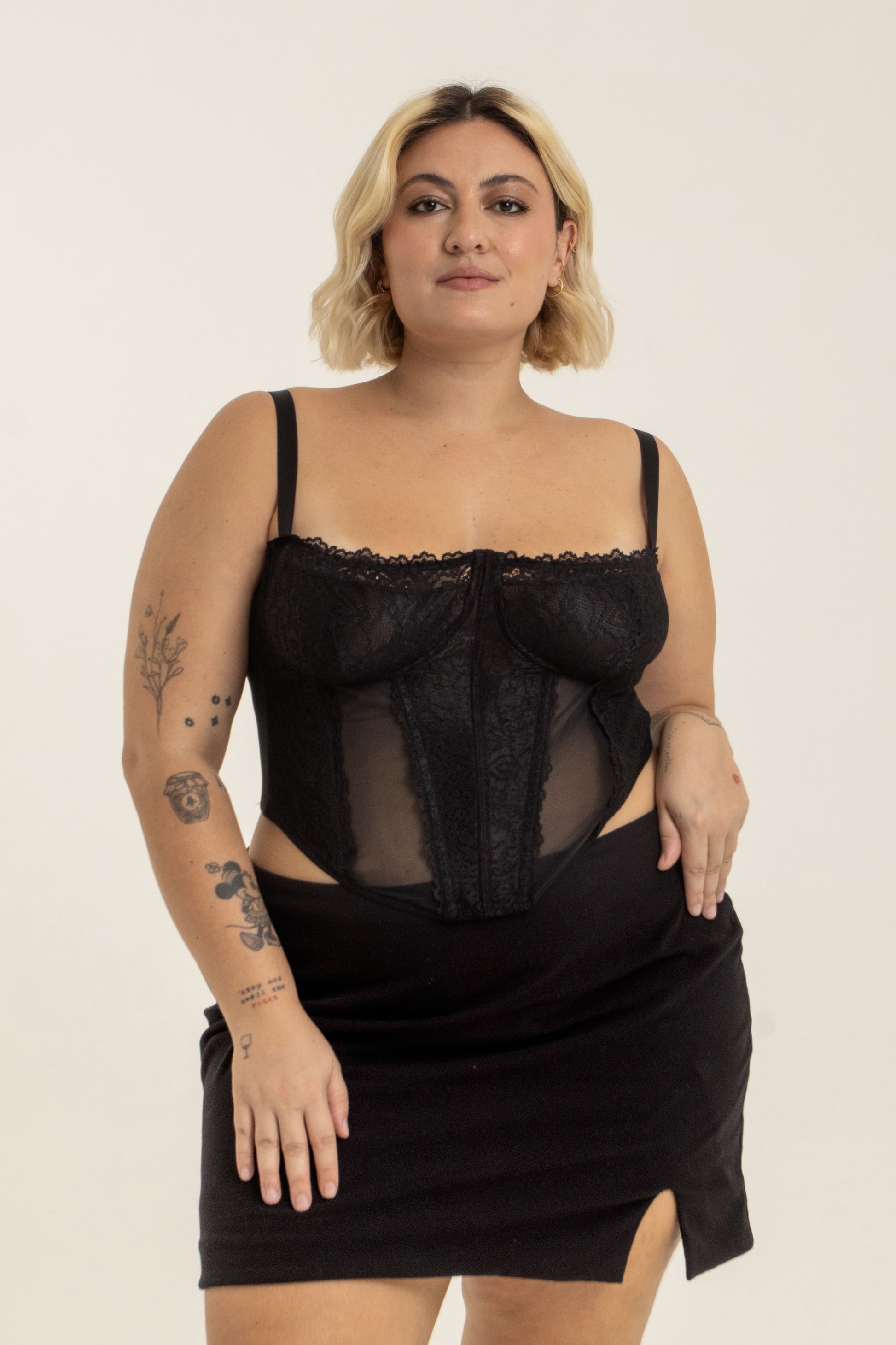 modelo veste corset plus size preto confortável, com renda, recortes e sustentação